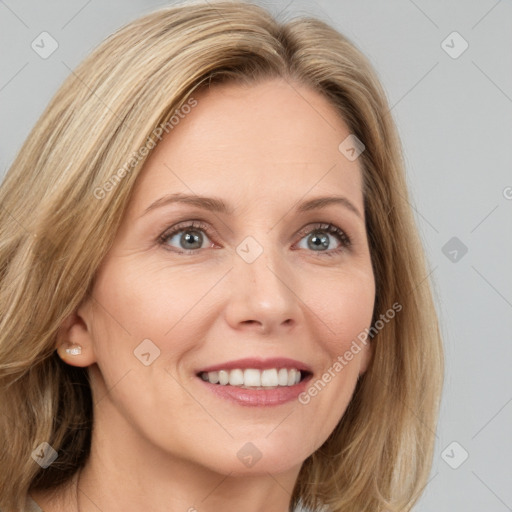 Joyful white adult female with medium  brown hair and blue eyes