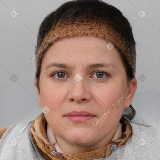 Joyful white young-adult female with short  brown hair and blue eyes