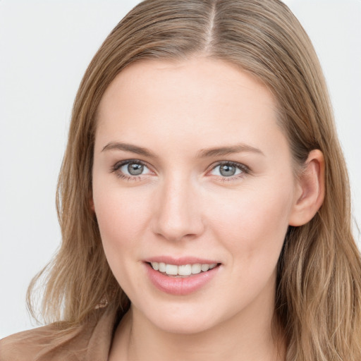 Joyful white young-adult female with long  brown hair and grey eyes