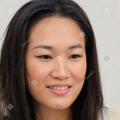 Joyful asian young-adult female with long  brown hair and brown eyes