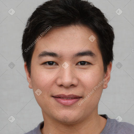 Joyful asian young-adult male with short  black hair and brown eyes