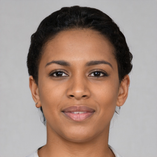 Joyful latino young-adult female with short  black hair and brown eyes