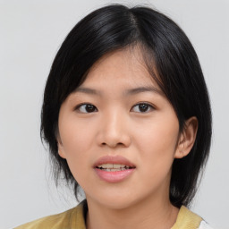 Joyful asian young-adult female with medium  black hair and brown eyes