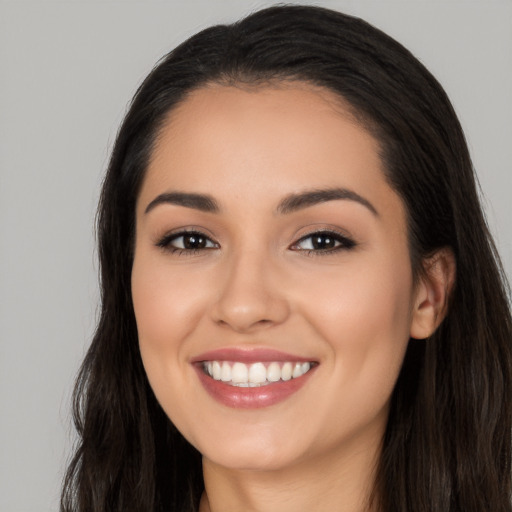 Joyful white young-adult female with long  black hair and brown eyes