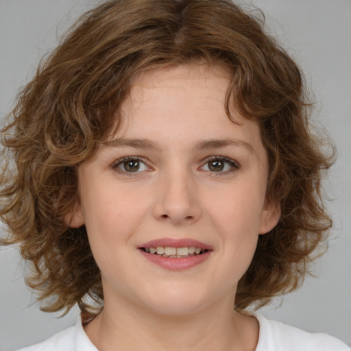 Joyful white child female with medium  brown hair and brown eyes