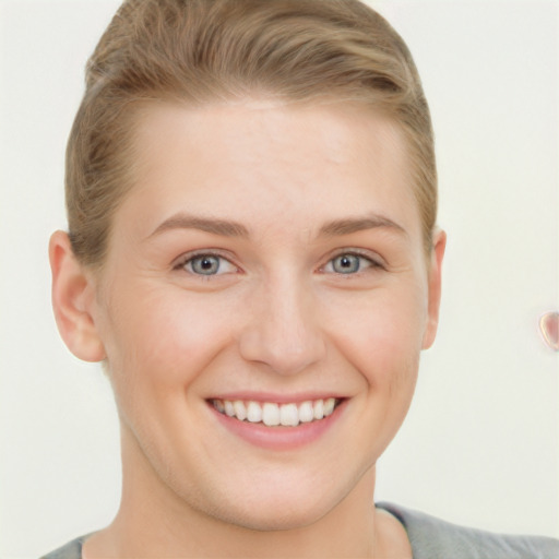 Joyful white young-adult female with short  brown hair and grey eyes