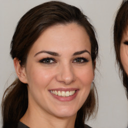 Joyful white young-adult female with medium  brown hair and brown eyes