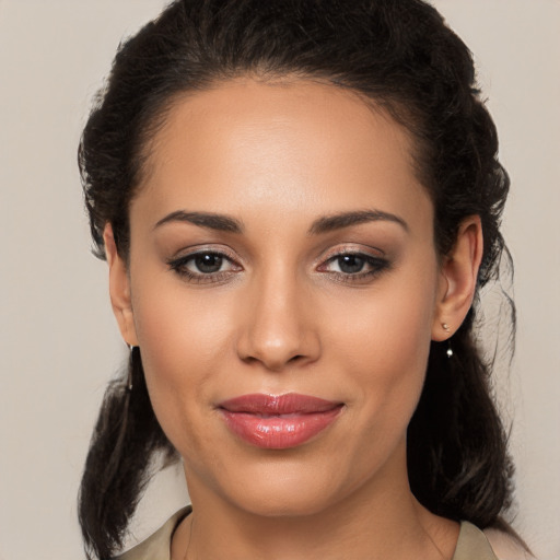 Joyful latino young-adult female with medium  brown hair and brown eyes