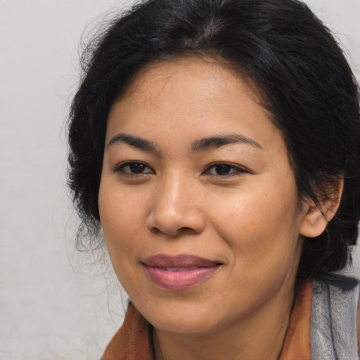 Joyful asian young-adult female with long  brown hair and brown eyes