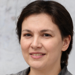 Joyful white adult female with medium  brown hair and brown eyes