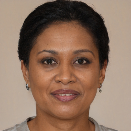 Joyful latino adult female with short  brown hair and brown eyes