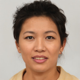 Joyful asian young-adult female with short  brown hair and brown eyes