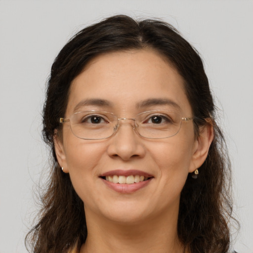 Joyful white adult female with long  brown hair and brown eyes