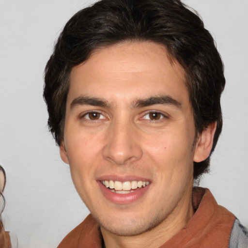 Joyful white young-adult male with medium  brown hair and brown eyes