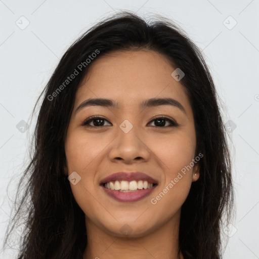 Joyful latino young-adult female with long  brown hair and brown eyes