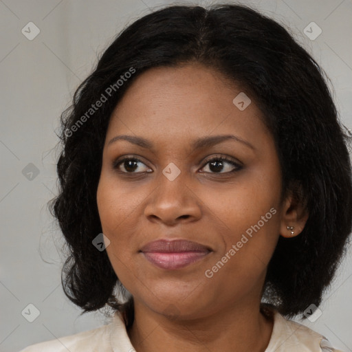 Joyful black adult female with medium  brown hair and brown eyes