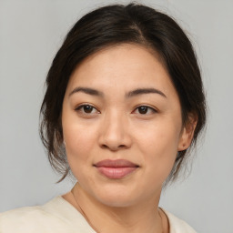 Joyful asian young-adult female with medium  brown hair and brown eyes