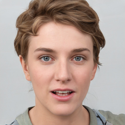 Joyful white young-adult female with short  brown hair and blue eyes