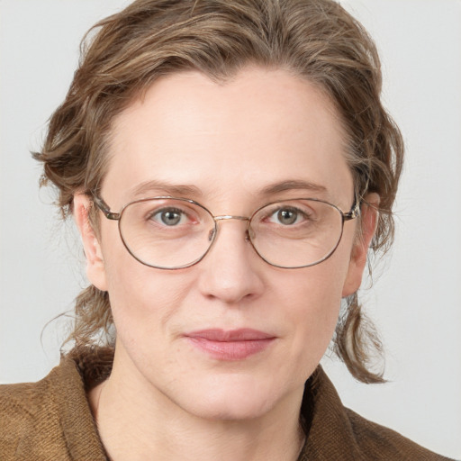 Joyful white adult female with medium  brown hair and blue eyes