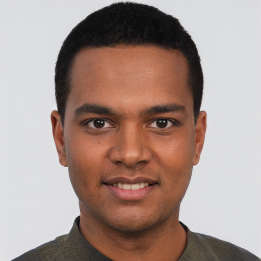 Joyful black young-adult male with short  black hair and brown eyes