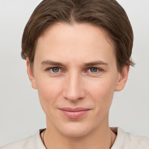 Joyful white young-adult female with short  brown hair and grey eyes