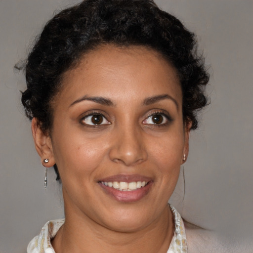 Joyful latino young-adult female with short  brown hair and brown eyes