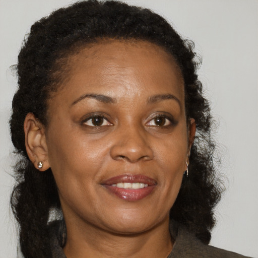 Joyful black adult female with medium  brown hair and brown eyes
