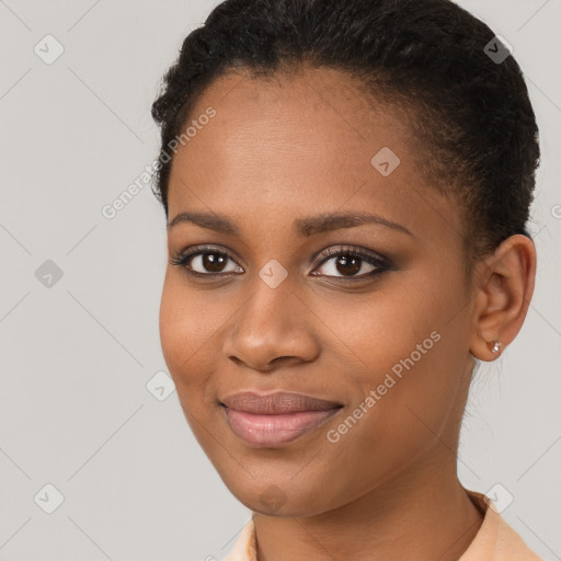 Joyful black young-adult female with short  brown hair and brown eyes