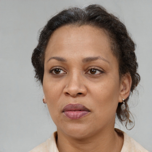 Joyful black adult female with medium  brown hair and brown eyes