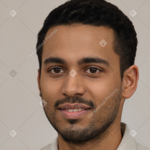 Joyful black young-adult male with short  black hair and brown eyes