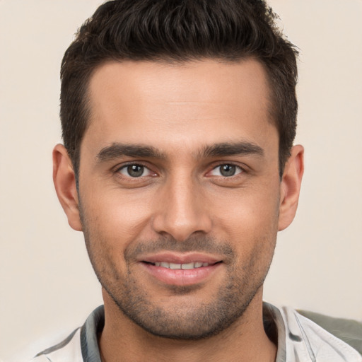 Joyful white young-adult male with short  brown hair and brown eyes