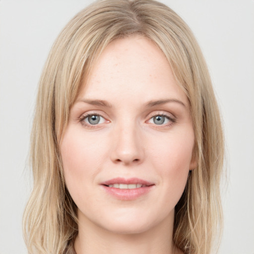 Joyful white young-adult female with long  brown hair and blue eyes