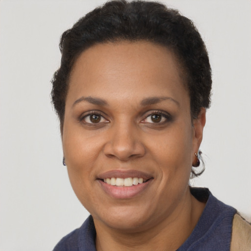 Joyful black young-adult female with short  brown hair and brown eyes