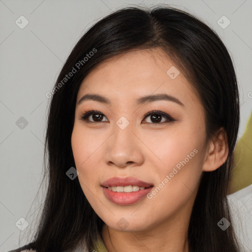 Joyful asian young-adult female with long  brown hair and brown eyes