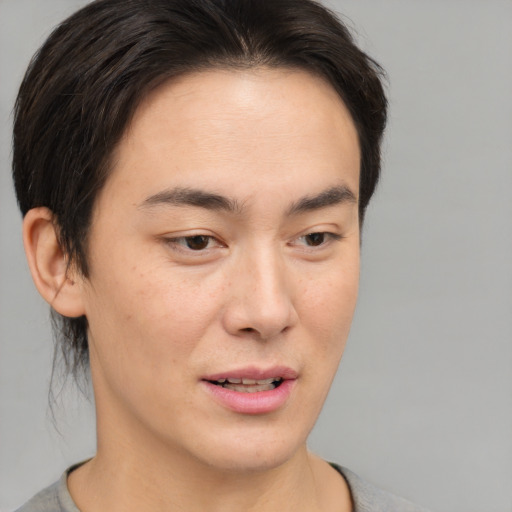 Joyful asian young-adult male with short  brown hair and brown eyes