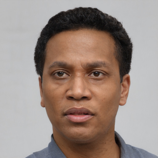Neutral latino adult male with short  black hair and brown eyes