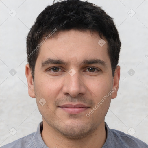 Joyful white young-adult male with short  black hair and brown eyes