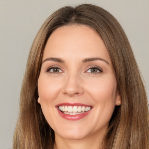 Joyful white young-adult female with long  brown hair and brown eyes