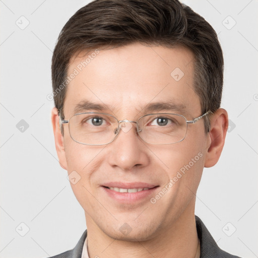 Joyful white young-adult male with short  brown hair and grey eyes