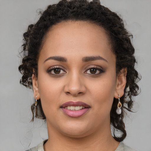 Joyful latino young-adult female with medium  brown hair and brown eyes