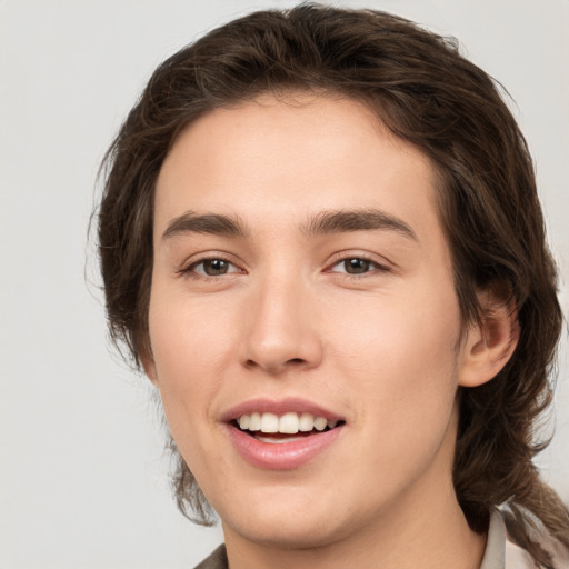 Joyful white young-adult male with medium  brown hair and brown eyes