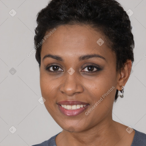 Joyful black young-adult female with short  black hair and brown eyes