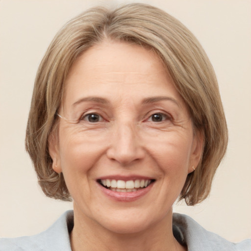 Joyful white adult female with medium  brown hair and blue eyes