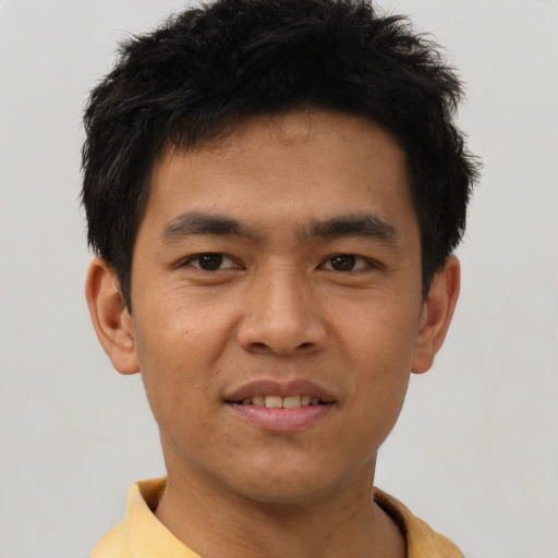 Joyful asian young-adult male with short  brown hair and brown eyes