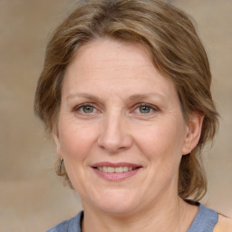 Joyful white adult female with medium  brown hair and grey eyes