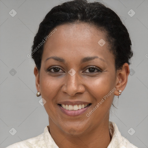 Joyful black adult female with short  brown hair and brown eyes