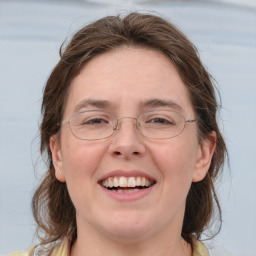 Joyful white adult female with medium  brown hair and grey eyes