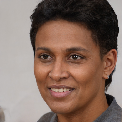 Joyful latino adult female with short  brown hair and brown eyes