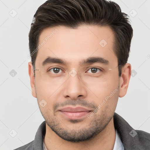 Joyful white young-adult male with short  brown hair and brown eyes