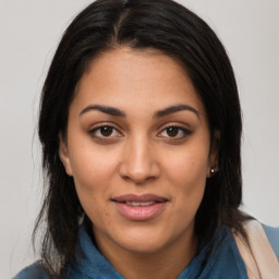 Joyful latino young-adult female with long  brown hair and brown eyes